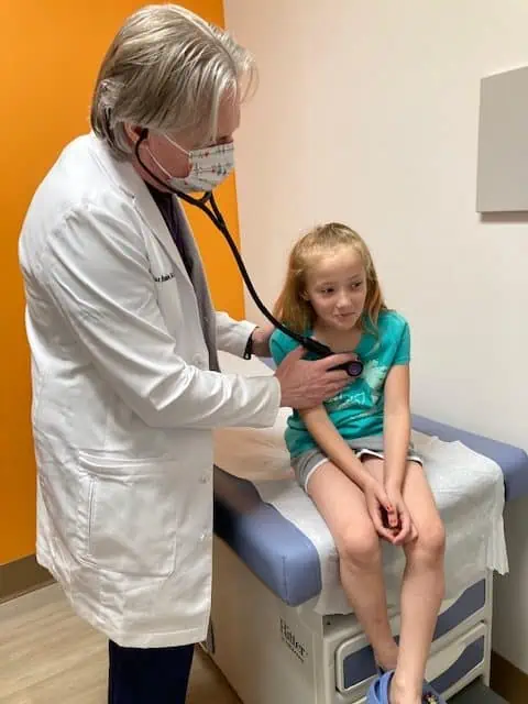 Doctor examining young child.